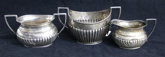 Two George V silver two handled sugar bowls and a similar silver cream jug, 13 oz.